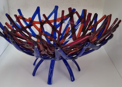 Woven glass nest bowl in blue, red and orange by Nel Zandbergen
